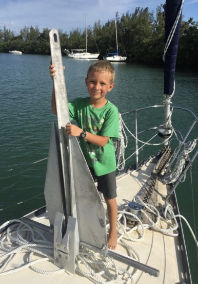 My son holding our storm anchor that is larger than him.